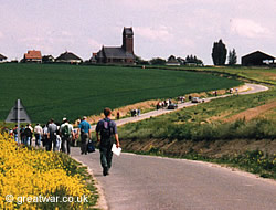 Guided walking tour on the Somme battlefield, walking towards Thiepval church.